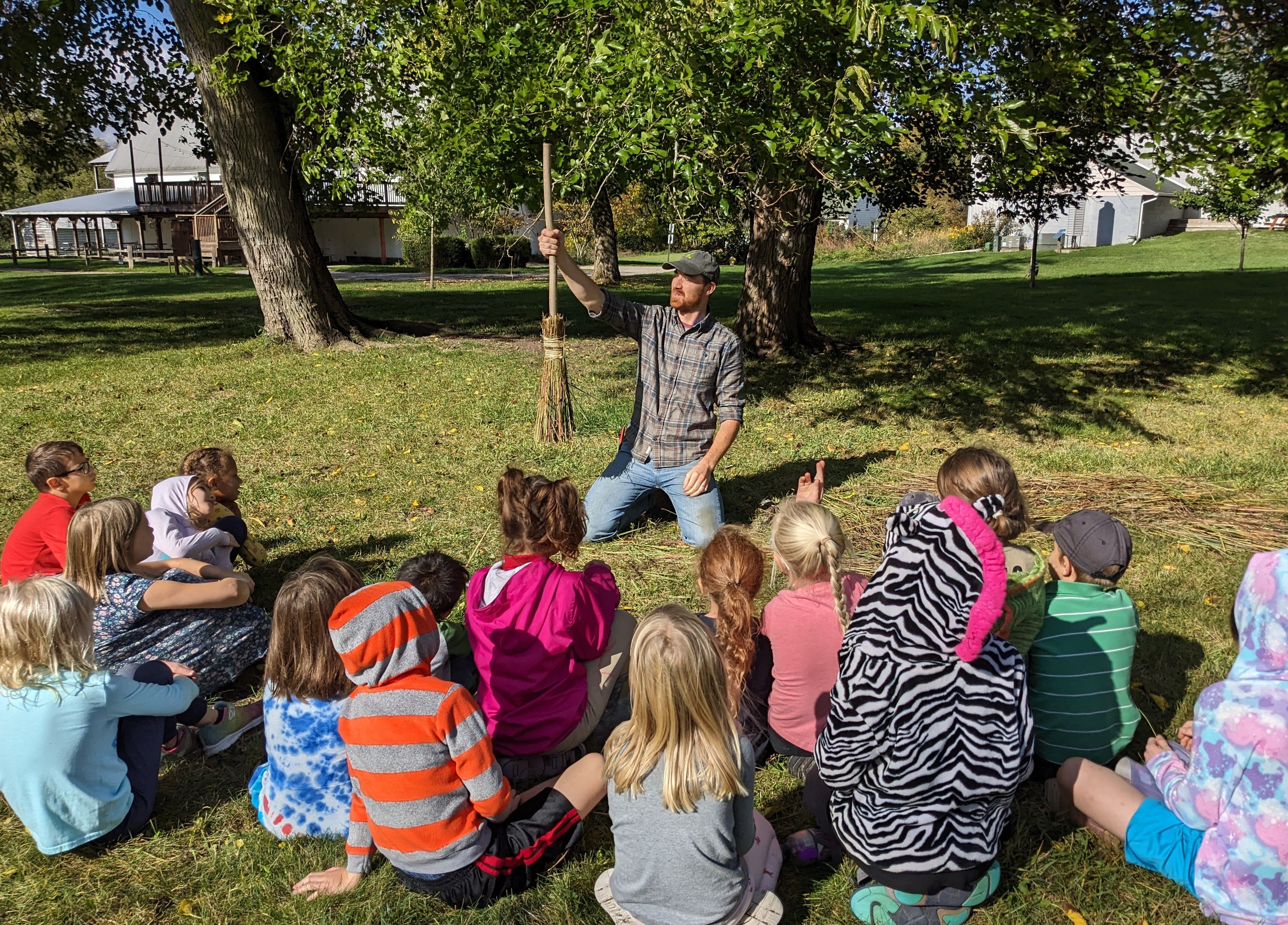 teacher instructing students outdoors