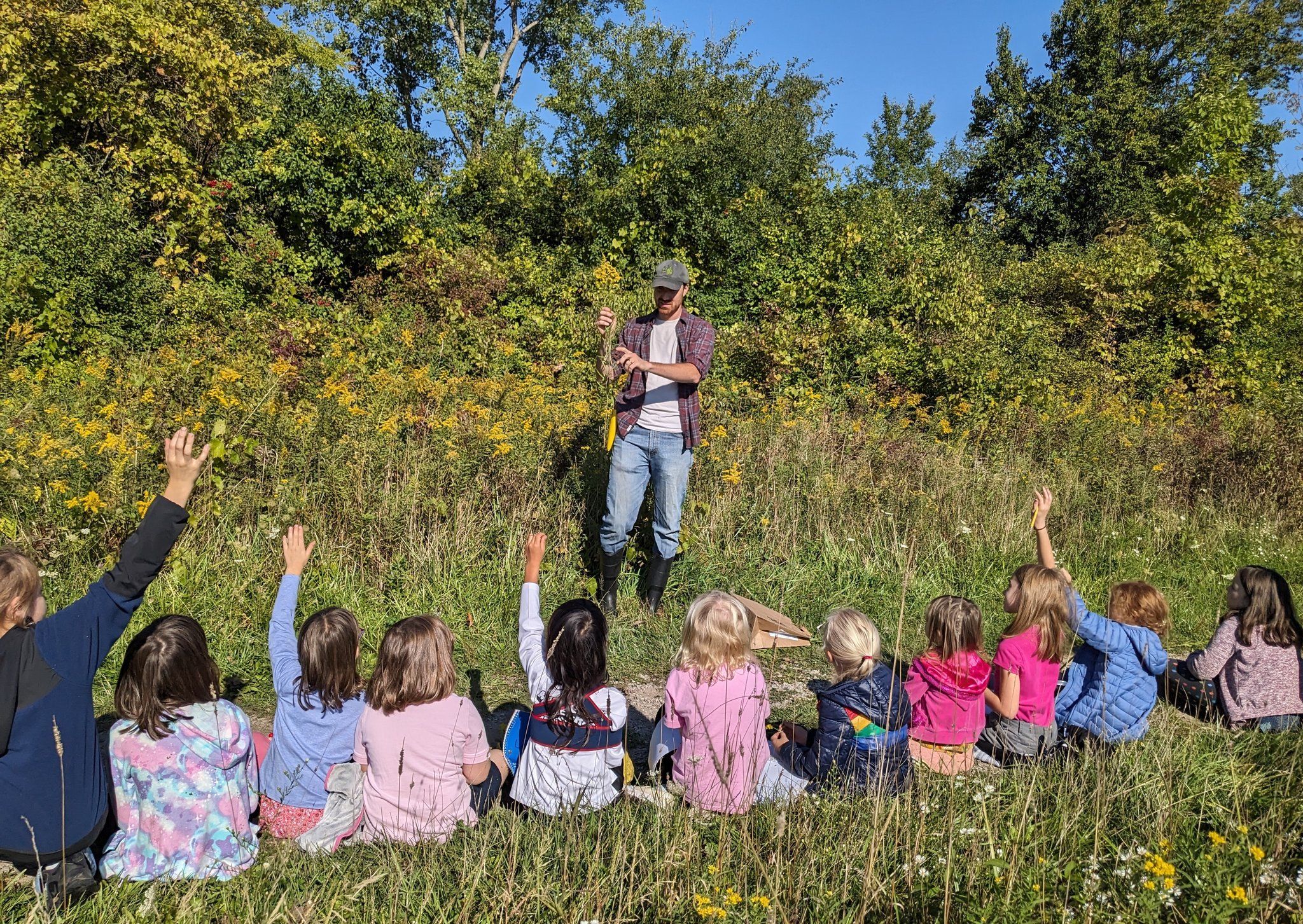 teacher instructing students outdoors